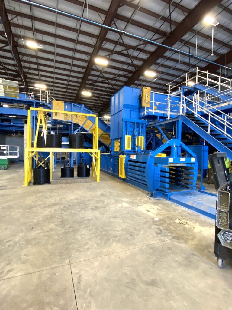 blue and yellow auto tie single ram baler